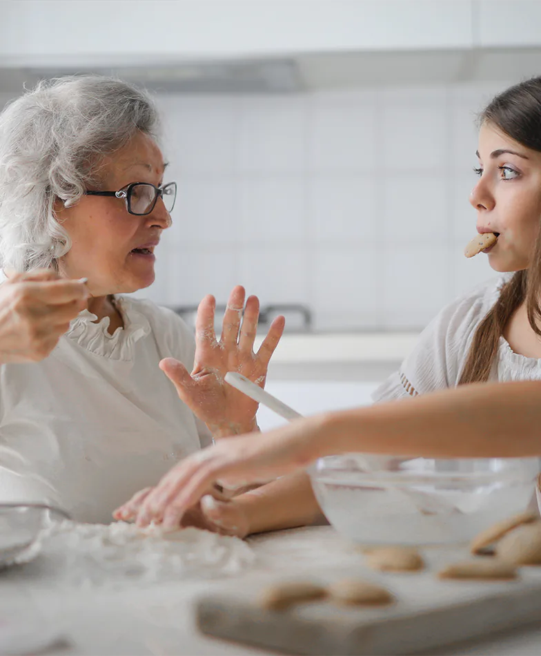 Grand-mother and grand-daughter baking cookies