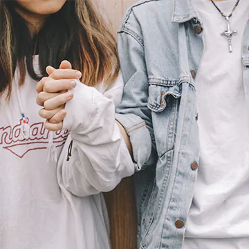 Twenty-something couple holding hands