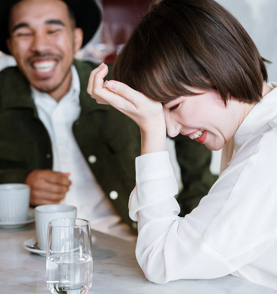 Young adults sharing a laugh over coffee